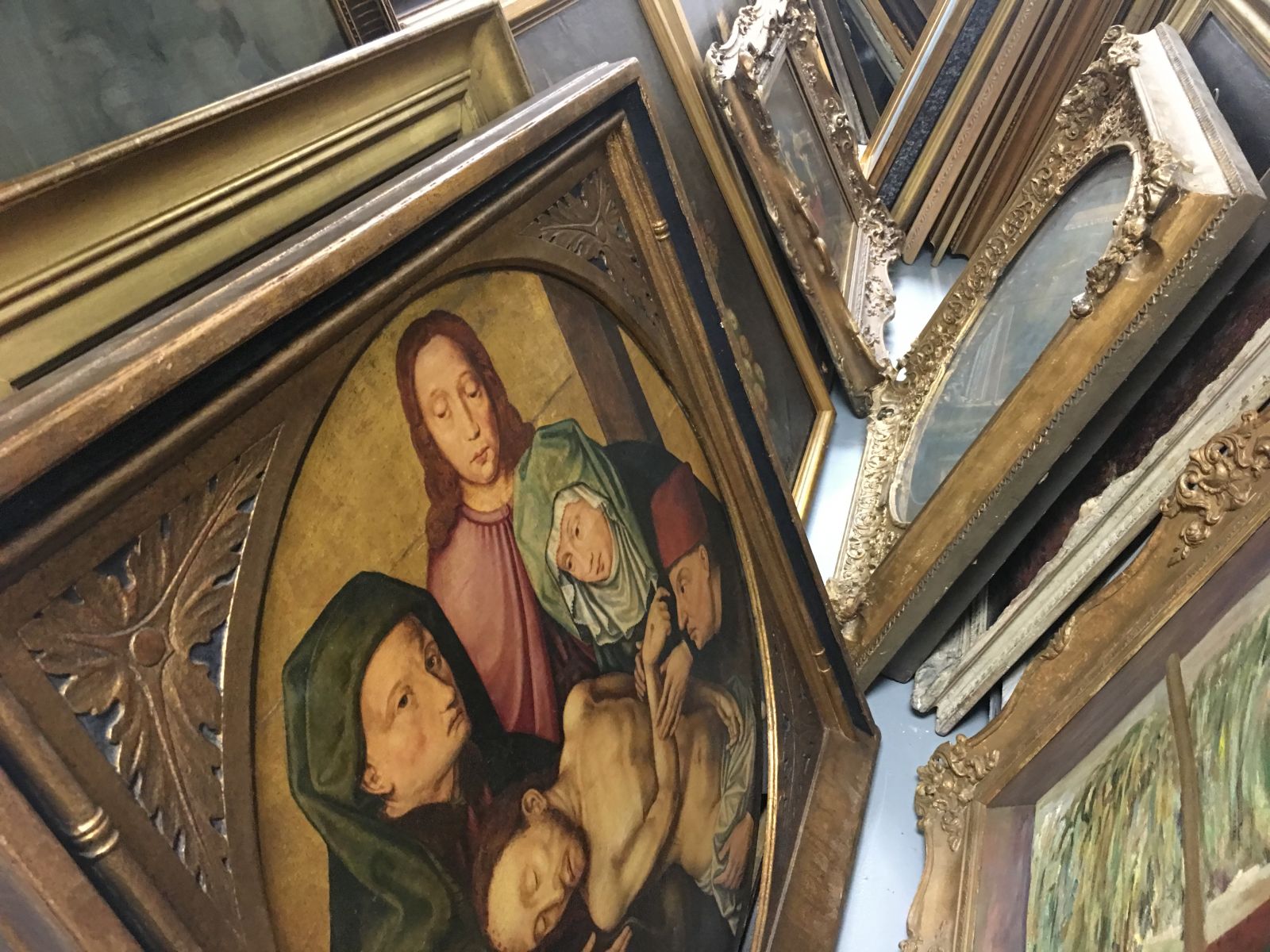 Fine works of art from old masters to more contemporary paintings stand back to back inside a storage locker.